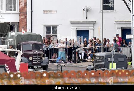 Harry Styles and Tom Hardy fans wait in Weymouth, Dorset as they are due to be filming the war movie Dunkirk. Weymouth harbour has period vehicles and boats for the WWII scenes. Many streets were closed and will remain closed tomorrow as filming continues Stock Photo