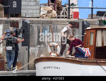 Harry Styles and Tom Hardy fans wait in Weymouth, Dorset as they are due to be filming the war movie Dunkirk. Weymouth harbour has period vehicles and boats for the WWII scenes. Many streets were closed and will remain closed tomorrow as filming continues Stock Photo