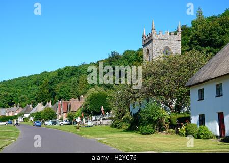 View along the pretty village street with the church in the foreground, Milton Abbas, Dorset, England, UK, Western Europe. Stock Photo