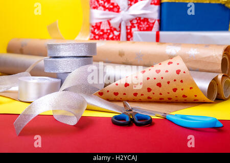 Gift wrapping, boxes, paper, ribbon and scissors on color background.  Materials and accessories for wrapping presents. Close up Stock Photo -  Alamy