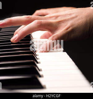Close up shot of male hands playing piano with selective focus Stock Photo
