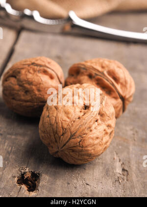 Three walnuts on a wooden table, close up shot Stock Photo