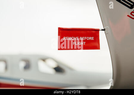 Remove before flight tag on an airplane wing Stock Photo