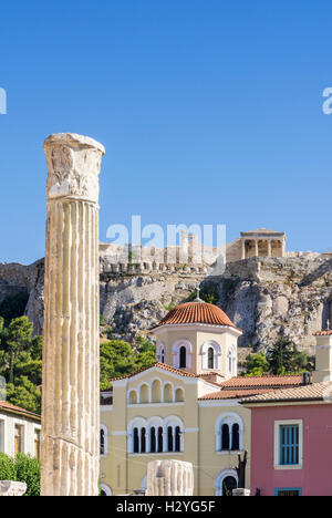 A column from Hadrian's Library overlooked by the Erechtheion on the north side of the Acropolis, Athens, Greece Stock Photo