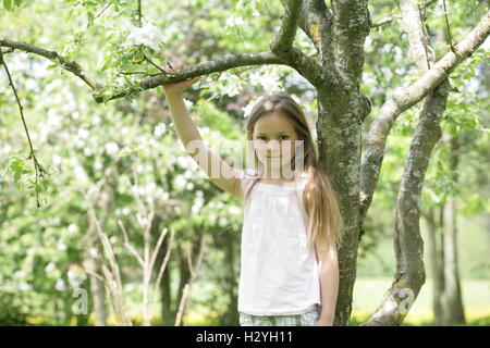 Girl standing under a tree Stock Photo