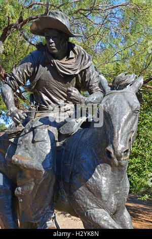 A cowboy on horseback is one of around 50 bronze statues of an old west cattle drive in Pioneer Plaza, downtown Dallas, Texas. Stock Photo