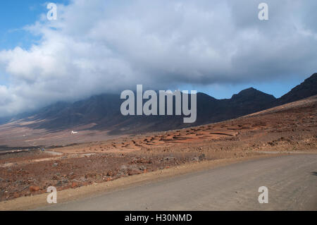 Fuerteventura, Canary Islands, North Africa, Spain: stone wall on the dirt road to Cofete, a remote village in the Morro Jable mountain range Stock Photo