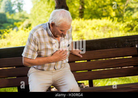 Old man holding his stomach. Stock Photo