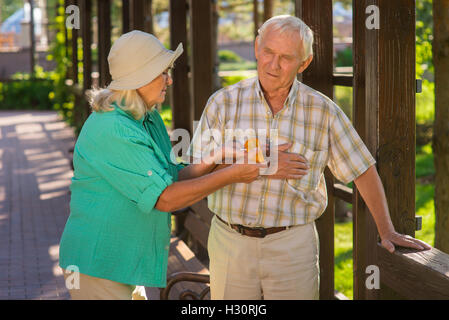 Woman giving pills to man. Stock Photo