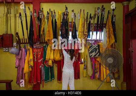 Phuket, Thailand. 3rd Oct, 2016. A devotee from the Chinese Sam Ong Hoo Shrine looking for a dress ahead of a street procession during the yearly Vegetarian Festival, also knows as Nine Emperor Gods Festival in Phuket on October 03, 2016. The Vegetarian Festival described as a colorful event, is held during the ninth lunar month of the Chinese calendar, and celebrate by the Chinese community of Phuket, where the devotees belief that abstinence from all kind of meat will help them obtain good health along their life. Credit:  Guillaume Payen/ZUMA Wire/Alamy Live News Stock Photo