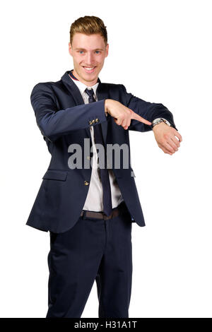 Young businessman dressed in a suit points to at watch Stock Photo