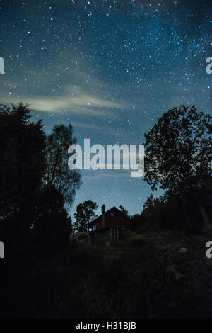 Little house at the night with the starry sky. Stock Photo