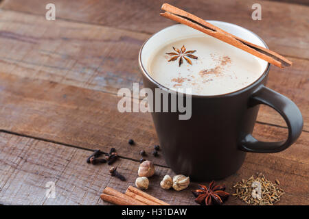 masala chai with spices. Cinnamon Stick, Thai Cardamom, Ginger, Clove, Star Anise, Black Peppercorns, Fennel Seeds, Black Tea Stock Photo