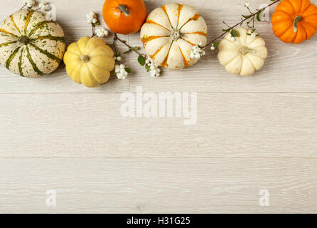 Miniature pumpkins on rustic wood background. Simple, natural country style fall autumn decorations. Stock Photo