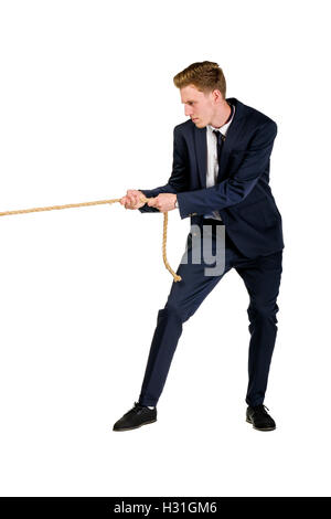 Young businessman pulling a rope Stock Photo