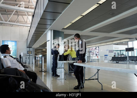 A passenger being checked up in security checkpoint before entering flight departure gate at La Aurora International Airport in Guatemala city in Guatemala central America Stock Photo