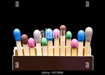 Multi-coloured matches in a box (a black background). Background layout with free text space. Stock Photo