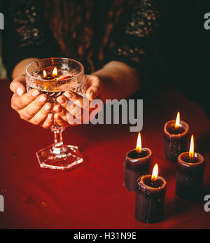 witch holds candle divination Stock Photo