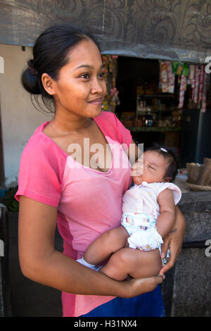 Indonesia, Bali, Lovina, Anturan Village, young mother with baby daughter in arms Stock Photo