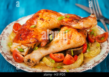 Oven - roasted chicken legs with vegetables, ready to eat Stock Photo