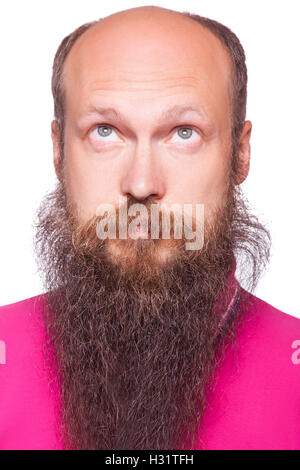 Portrait of the young bald thinking man with beard looks up. isolated on white. Stock Photo