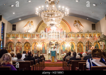 Priest during a service at a Greek Orthodox Church in Greektown in Baltimore, Maryland Stock Photo