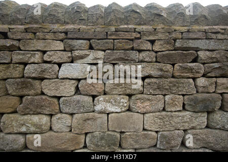 Section of high old grey to brown dry stone wall near Bamford England Stock Photo