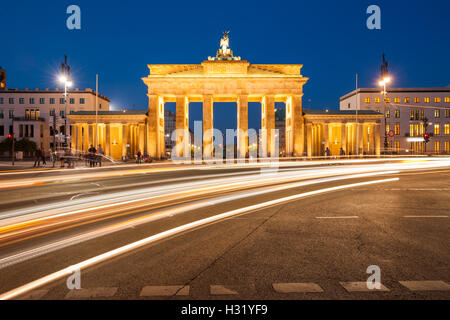 Berlin's Brandenburg Gate at twilight with speeding traffic light trails Stock Photo