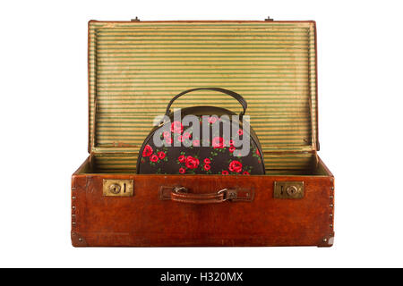 Old vintage open suitcase with roses themed hand luggage isolated on white background Stock Photo