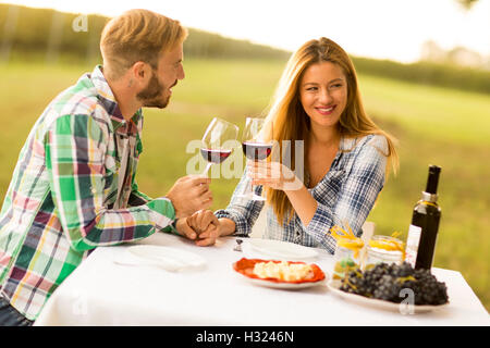 Young couple having dinner at vineyard countryside Stock Photo