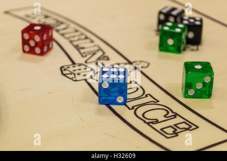 Playing Dice on a board inside of the Cardiff Arcades store Rules of play. Stock Photo