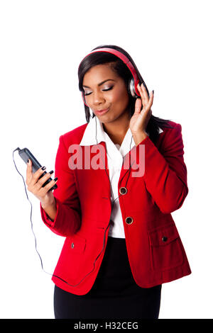 Beautiful happy business woman jamming listening to music on wireless mobile phone, on white. Stock Photo