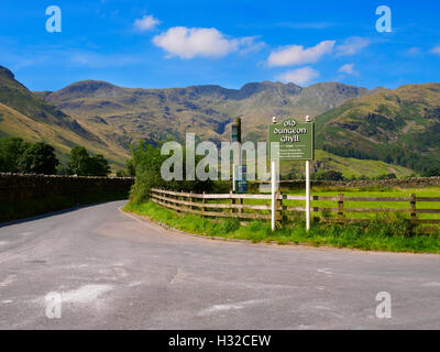 Crinkle Crags and the Sign for the Old Dungeon Ghyll Hotel, Great Langdale, Lake District Stock Photo