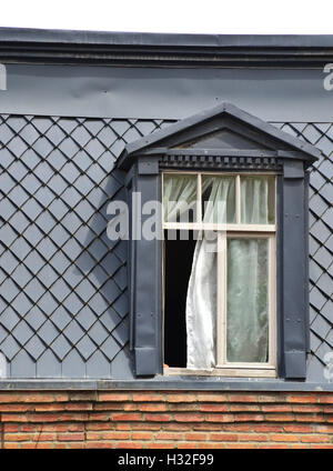 Old window on the roof Stock Photo