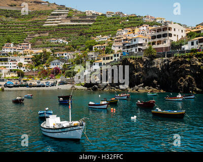 Colourful boats lie at anchor in the bay of Camara de Lobos on the Portuguese island of Madeira Stock Photo