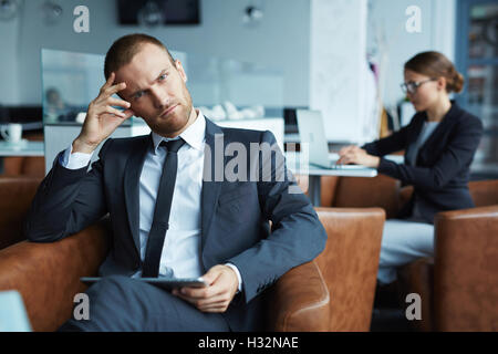 Serious young businessman in cafe Stock Photo
