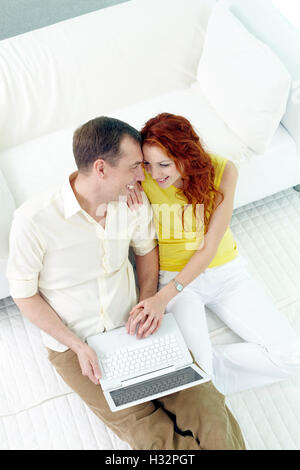 Happy couple using laptop Stock Photo