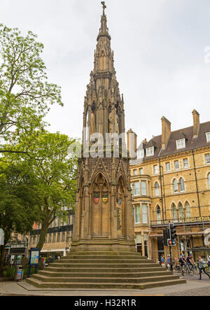 Huge & ornate 19th century gothic style Martyrs monument in Oxford with background of historic buildings & people strolling past Stock Photo