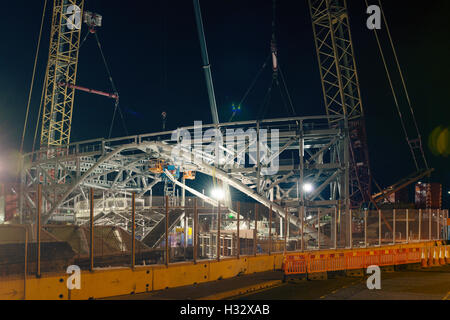 Steelwork arch installation,a significant engineering operation,Dundee,UK.Both halves of arch are connected and secured. Stock Photo