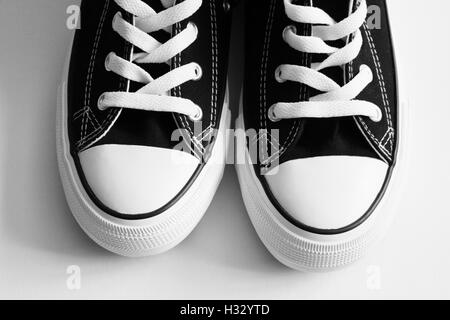 New black sneakers close up isolated on white Stock Photo