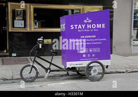 A delivery tricycle for environmentally friendly NEXT CLEANERS photographed on West 3rd Street in Greenwich Village, NYC. Stock Photo