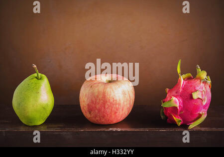 Three of fruits on a wooden with vintage style. Stock Photo