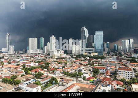 A tropical storm is coming over the business district of Kuningan in Jakarta, Indonesia capital city. Stock Photo
