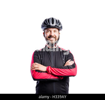 Hipster man in sports sweatshirt wearing helmet, studio shot Stock Photo