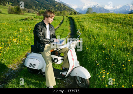 Man, 29, on a classic motor scooter, Allgaeu, Bavaria Stock Photo