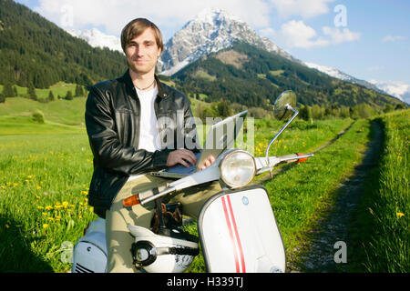 Man, 29, on a classic motor scooter, Allgaeu, Bavaria Stock Photo