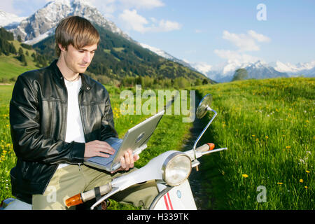 Man, 29, on a classic motor scooter, Allgaeu, Bavaria Stock Photo