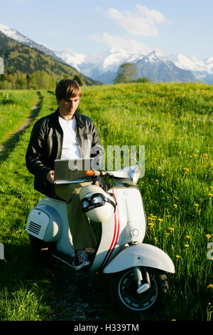 Man, 29, on a classic motor scooter, Allgaeu, Bavaria Stock Photo