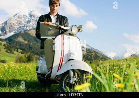 Man, 29, on a classic motor scooter, Allgaeu, Bavaria Stock Photo
