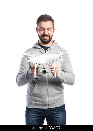 Man holding drone. Studio shot on white background, isolated Stock Photo